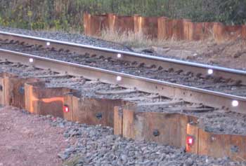 Reflective targets for monitoring railline and piling settlement.